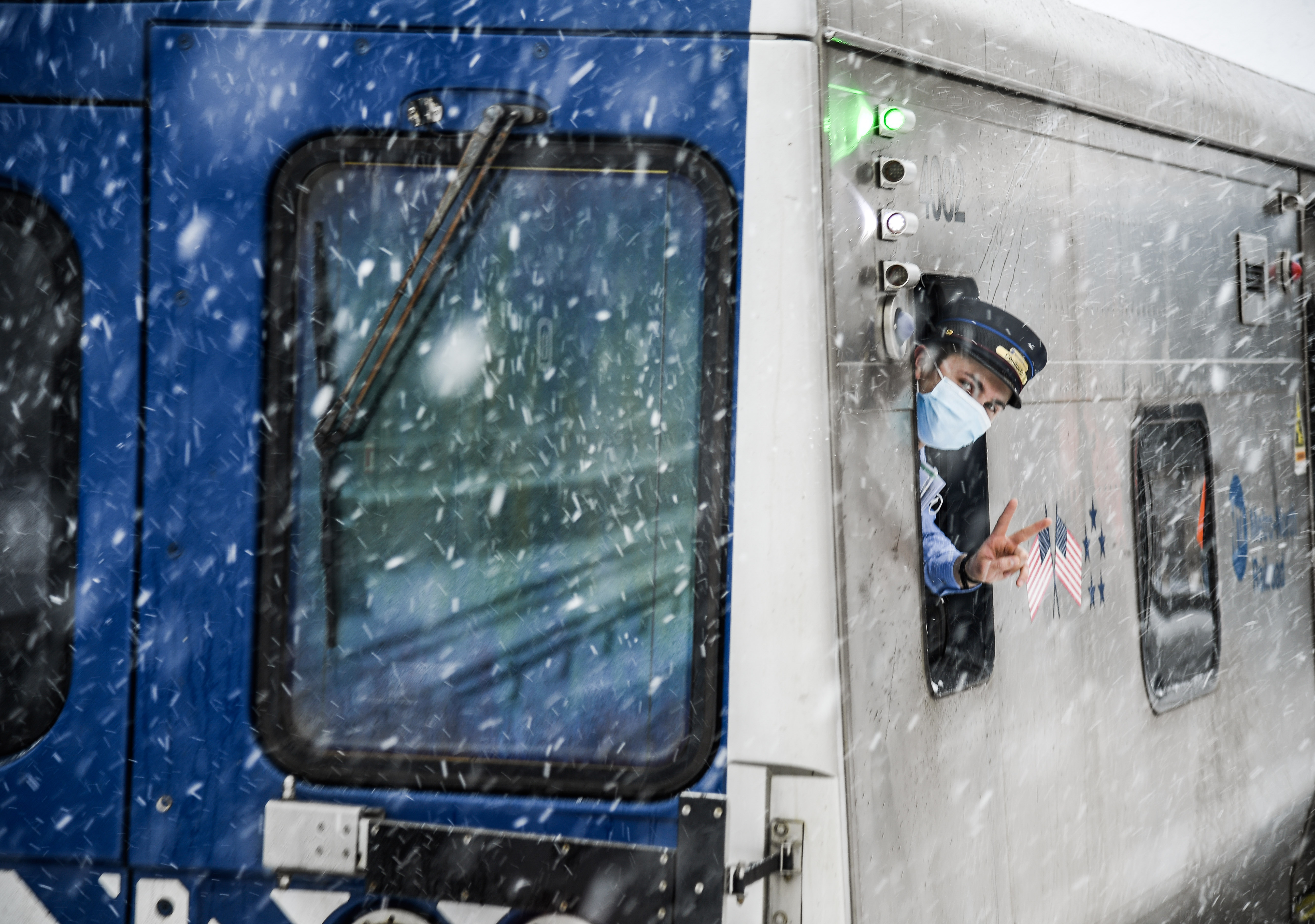 an mta employee on a train during a snowstorm