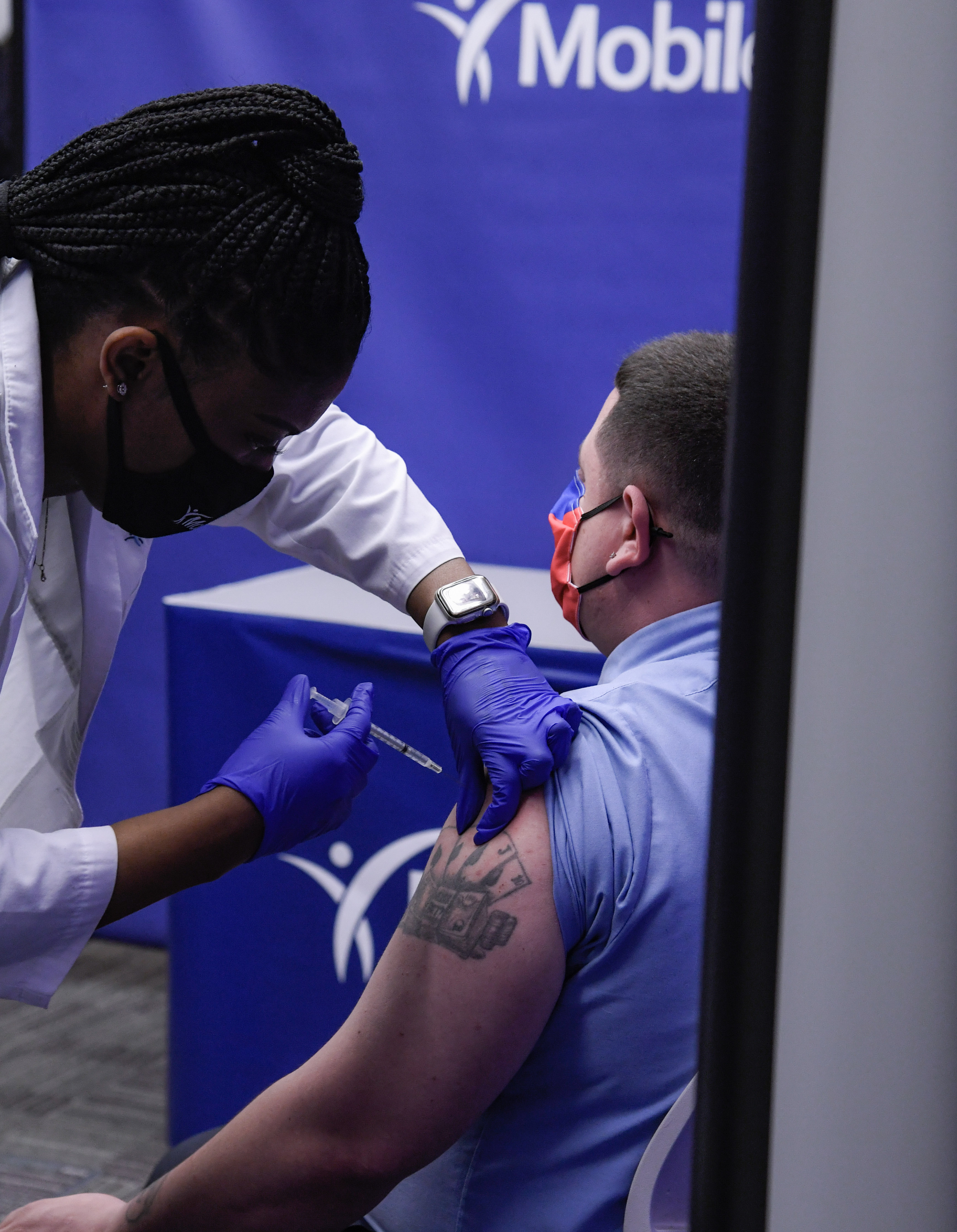 an mta employee receives the COVID vaccine at the newly opened center in brooklyn