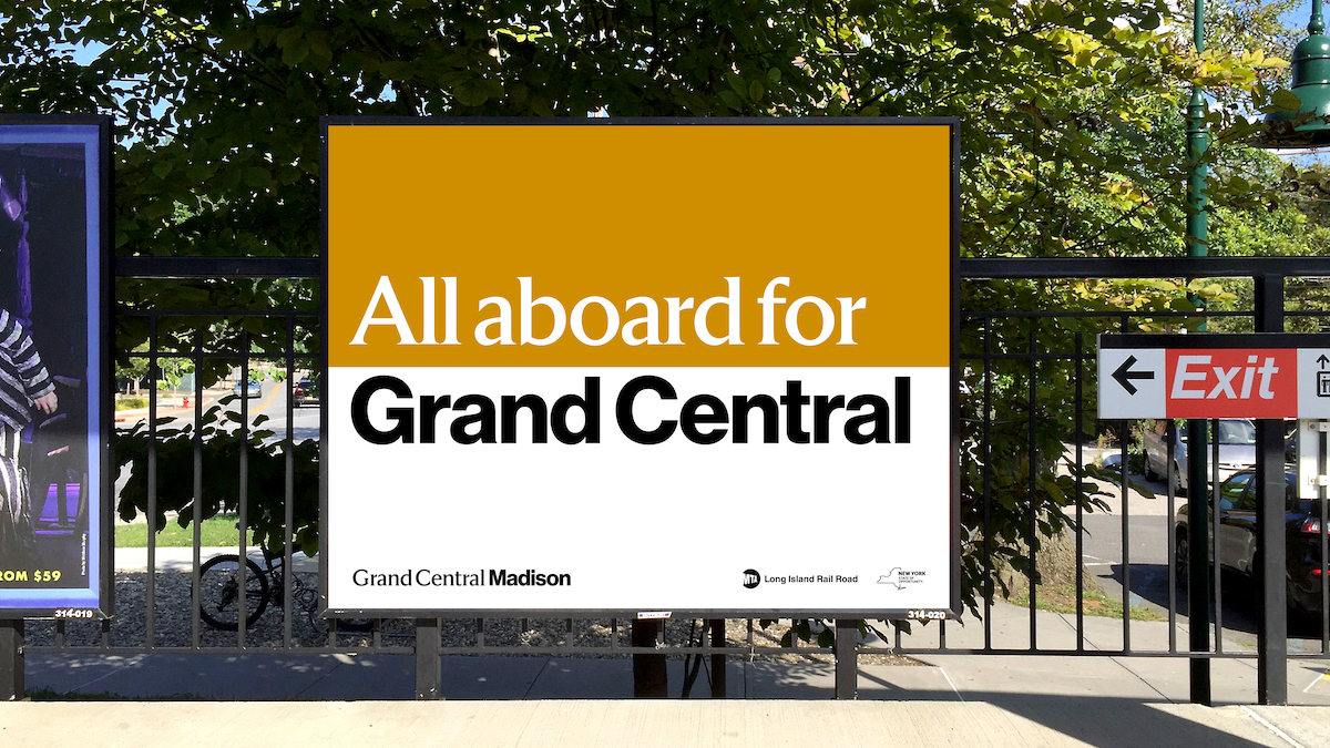A sign at a train station that reads "All Aboard to Grand Central" 