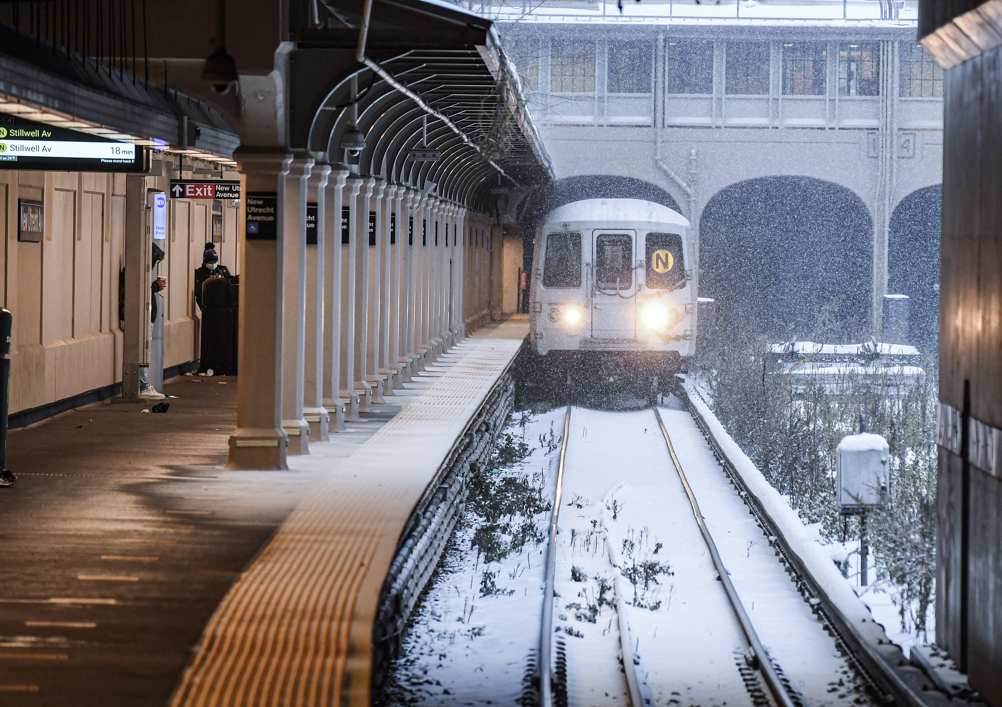 N train pulling into New Utrecht Avenue station during winter storm