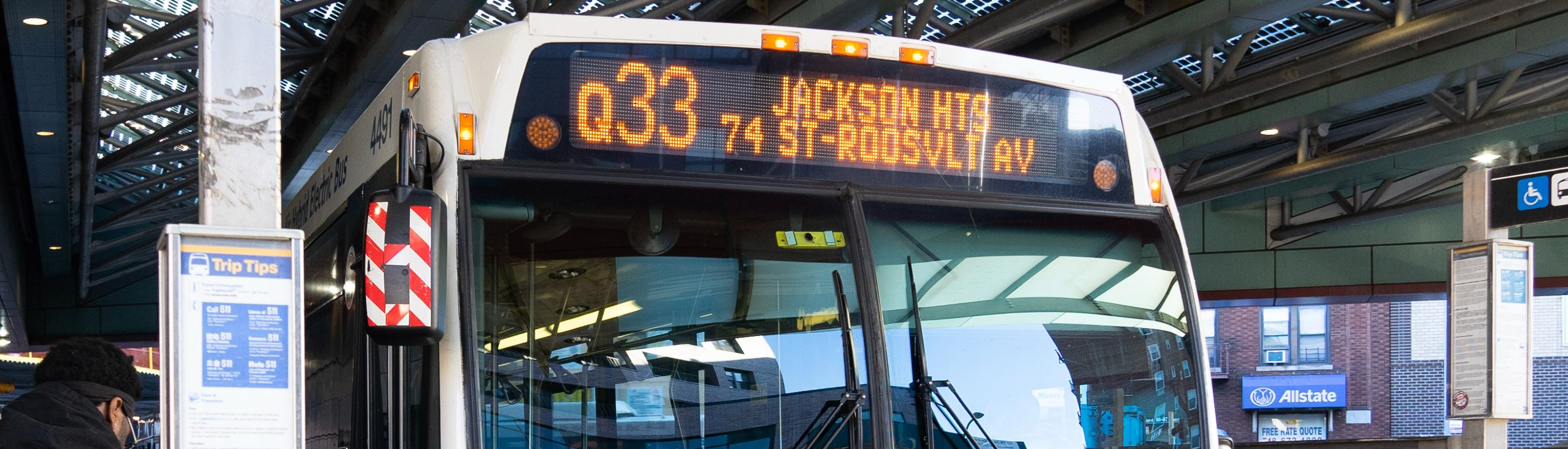 A bus with an electric screen at the top that reads Q53