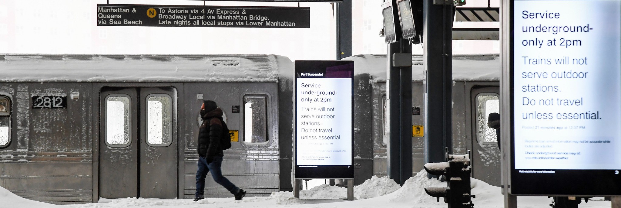 A person on a subway platform during a snowstorm.