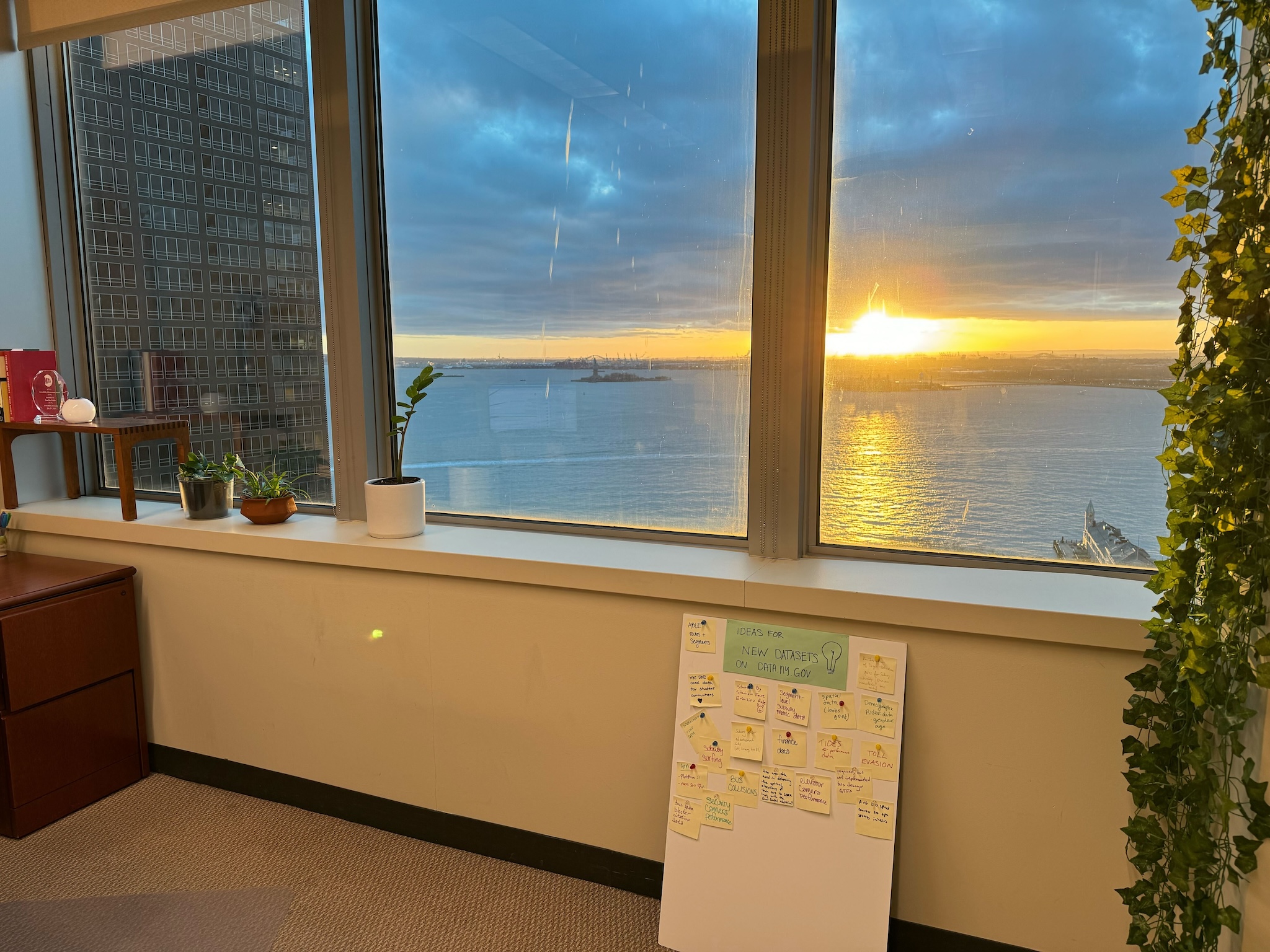 The sunset over the Statue of Liberty from inside an office