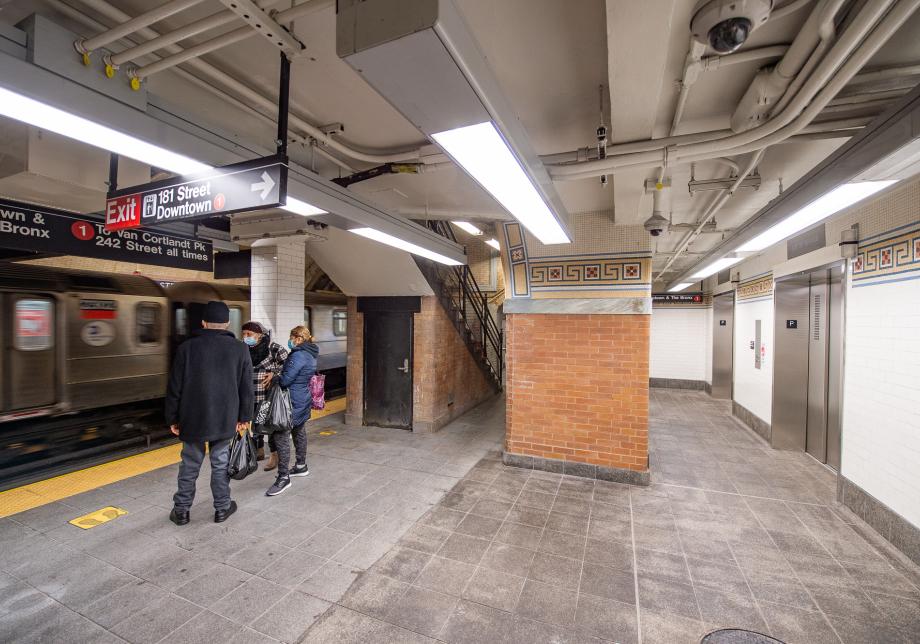 A subway platform with new elevators on the right side 
